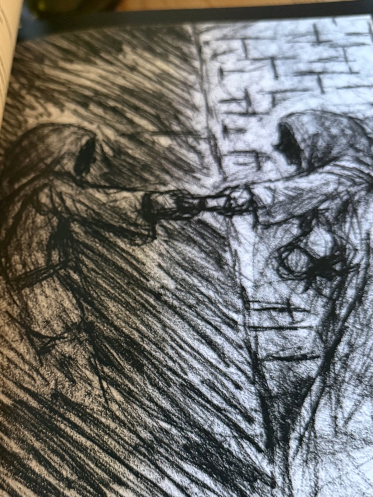 Chapter II open: two hooded figures clasping hands, from the pages on Contacts.