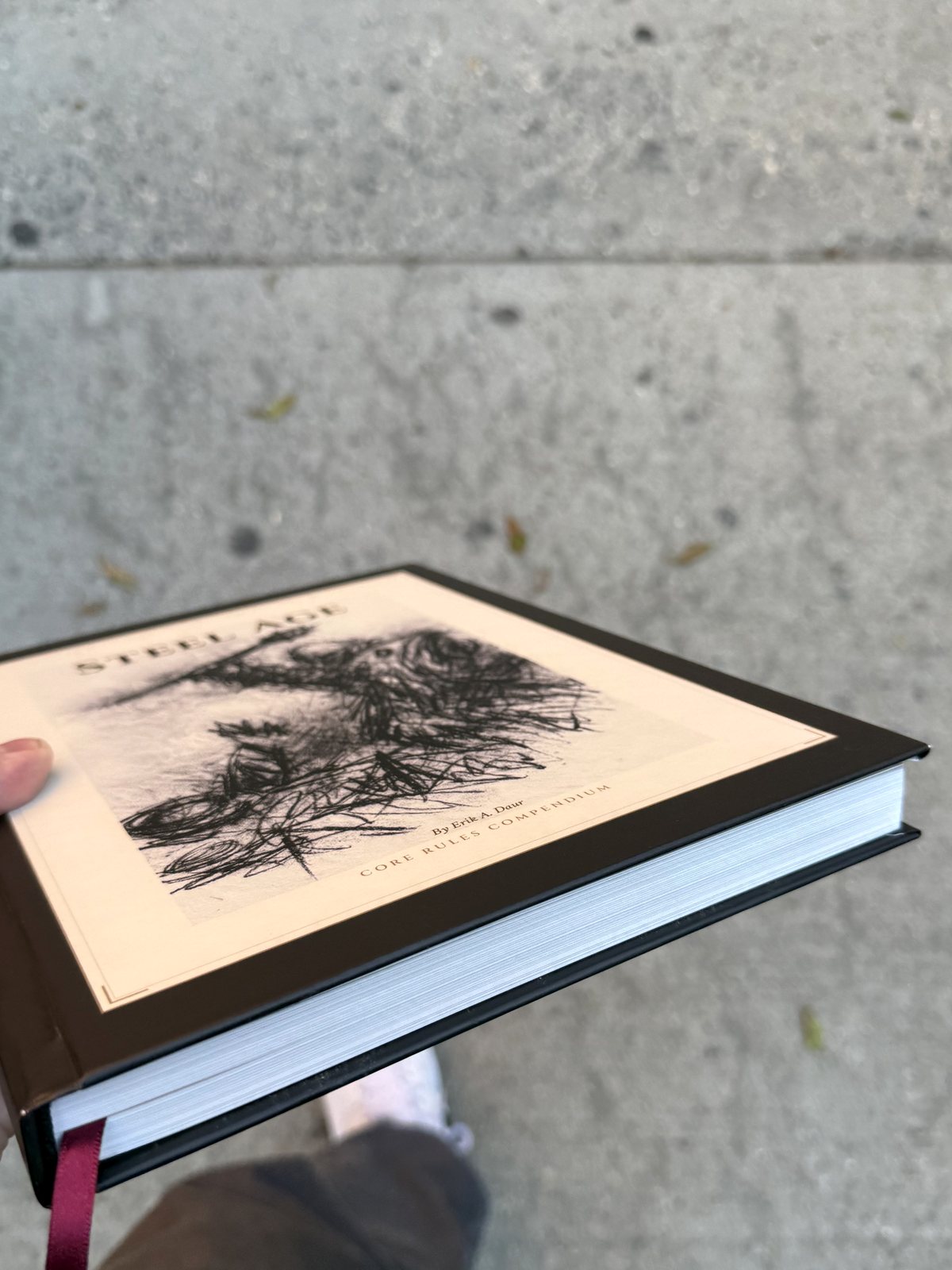 The page block and the red ribbon marker, the book held closed.